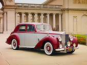 AUT 21 RK2507 01
1954 Rolls-Royce Silver Dawn Silver And Maroon 3/4 Front View On Pavement By Building