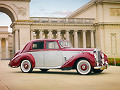 AUT 21 RK2508 01
1954 Rolls-Royce Silver Dawn Silver And Maroon 3/4 Front View On Pavement By Building