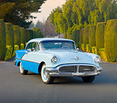 AUT 21 RK2615 01
1956 Oldsmobile Super 88 Blue On Road In Front Of Trees