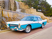 AUT 21 RK2634 01
Mercury Grand Marquis DeSoto Custom Blue And White 3/4 Front View On Pavement By Waterfall