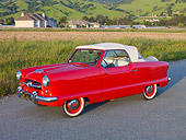 AUT 21 RK2640 01
1955 Nash Metropolitan Convertible Red 3/4 Side View On Pavement By Field And Houses