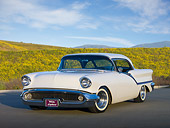 AUT 21 RK2715 01
1957 Oldsmobile Super 88 Holiday Coupe White 3/4 Front View On Pavement By Wildflowers
