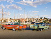 AUT 21 RK2777 01
1957 DeSoto Firedome Green And 1958 DeSoto Fireflite Orange 3/4 Rear View On Pavement By Harbor