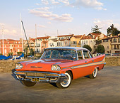 AUT 21 RK2779 01
1958 DeSoto Fireflite Orange 3/4 Front View On Pavement By Harbor