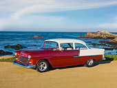 AUT 21 RK2837 01
1955 Chevrolet 210 2-Door Sedan Orange And White 3/4 Side View On Sand By Ocean