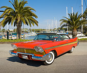 AUT 21 RK2848 01
1957 Plymouth Fury Red And Gold 3/4 Front View On Pavement By Harbor And Palm Trees