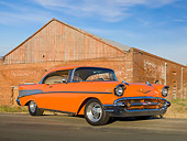 AUT 21 RK2858 01
1957 Chevrolet Bel Air Orange 3/4 Front View On Pavement By Old Brick Building