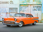 AUT 21 RK2867 01
1957 Chevrolet Bel Air Orange 3/4 Front View On Pavement By Old Factory Building