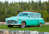 AUT 21 RK2879 01
1954 Dodge Coronet Suburban Sea Green 3/4 Front View On Grass By Stones And Pine Trees