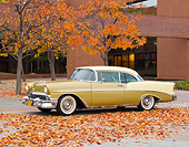 AUT 21 RK2898 01
1956 Chevrolet Bel Air Gold And Yellow 3/4 Side View On Pavement By Brick Building And Autumn Leaves
