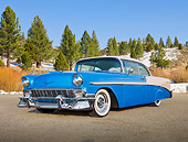 AUT 21 RK2916 01
1956 Chevrolet Bel Air Blue And White 3/4 Front View On Dirt Road By Snow And Pine Trees