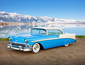 AUT 21 RK2928 01
1956 Chevrolet Bel Air Blue And White 3/4 Front View On Dirt Road By Snowy Peaks Reflected In Water