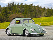 AUT 21 RK2969 01
1956 Volkswagen Bug Agave Green 3/4 Front View On Gravel By Grass And Trees