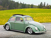 AUT 21 RK2972 01
1956 Volkswagen Bug Agave Green 3/4 Front View On Gravel By Grass And Trees