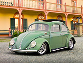 AUT 21 RK2973 01
1956 Volkswagen Bug Agave Green 3/4 Front View On Gravel By Yellow Building