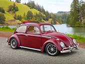 AUT 21 RK2980 01
1959 Volkswagen Beetle Red 3/4 Side View On Gravel By Water And Grassy Hills