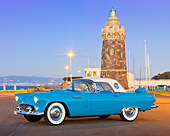 AUT 21 RK2992 01
1956 Ford Thunderbird Blue 3/4 Side View On Pavement By Marina At Night