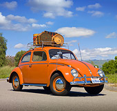 AUT 21 RK3030 01
1958 VW Bug Sedan Coral Red With Luggage 3/4 Front View On Pavement By Grass