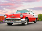 AUT 21 RK3061 01
1957 Oldsmobile 88 Red And White 3/4 Front View On Pavement By Fence And Flowers
