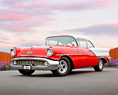AUT 21 RK3062 01
1957 Oldsmobile 88 Red And White 3/4 Front View On Pavement By Fence And Flowers