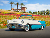 AUT 21 RK3087 01
1956 Oldsmobile Super 88 Teal And White 3/4 Front View On Pavement By Flowers