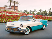 AUT 21 RK3093 01
1956 Oldsmobile Super 88 Teal And White 3/4 Front View On Pavement By Flowers