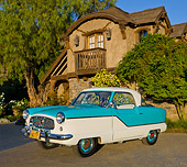 AUT 21 RK3158 01
1958 Nash Metropolitan Caribbean Blue And White 3/4 Front View On Pavement By House