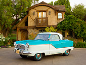 AUT 21 RK3162 01
1958 Nash Metropolitan Caribbean Blue And White 3/4 Front View On Pavement By House