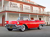 AUT 21 RK3185 01
1957 Cadillac El Dorado Barritz Red 3/4 Front View On Pavement By Old Hotel