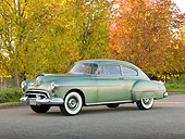 AUT 21 RK3209 01
1950 Oldsmobile Futuramic 88 Club Sedan Moss Green 3/4 Front View On Pavement By Autumn Trees