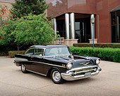 AUT 21 RK3222 01
1957 Chevrolet Bel Air Black 3/4 Front View On Pavement By Building