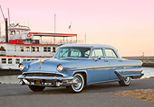 AUT 21 RK3281 01
1955 Lincoln Capri Blue and White 3/4 Front View On Pavement By Boat At Dusk