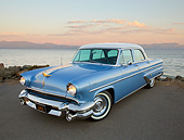 AUT 21 RK3283 01
1955 Lincoln Capri Blue and White 3/4 Front View On Pavement By Bay At Dusk
