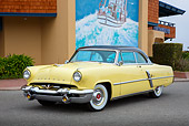 AUT 21 RK3294 01
1953 Lincoln Capri Yellow 3/4 Front View On Pavement By Mural