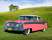 AUT 21 RK3295 01
1956 Nash Ambassador Custom Special V8 Ballerina Red, Boulevard Gray And Frost White 3/4 Front View On Grass