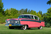 AUT 21 RK3296 01
1956 Nash Ambassador Custom Special V8 Ballerina Red, Boulevard Gray And Frost White 3/4 Front View On Grass By Trees