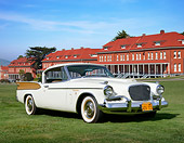 AUT 21 RK3310 01
1954 Studebaker Golden Hawk White And Gold 3/4 Front View On Grass By Buildings