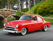 AUT 21 RK3315 01
1951 Chevrolet Red 3/4 Front View On Pavement By Pond And Bridge