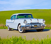 AUT 21 BK0002 01
1955 Pontiac Chieftan White 3/4 Front View On Pavement By Hills