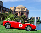 AUT 21 RK0041 03
1957 Red AC Ace Profile View On Grass Hill By Fountain And Building