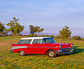 AUT 21 RK0045 01
1957 Chevy Nomad Wagon Red And White 3/4 Side View On Grass And Trees Blue Sky