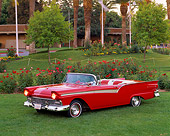 AUT 21 RK0057 01
1957 Ford Fairlane Convertible Red Overhead 3/4 Side View On Grass Lights On By Flowers