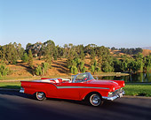AUT 21 RK0058 02
1957 Red Convertible Ford Fairlane 3/4 Side On Road By Lake And Trees