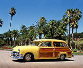 AUT 21 RK0072 07
1951 Ford Country Squire Woody Wagon Yellow On Pavement By Palm Trees