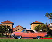 AUT 21 RK0090 20
1957 Lincoln Premier Pink 3/4 Front View On Road In Front Of Building