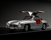 AUT 21 RK0117 06
1956 Mercedes-Benz 300SL Gullwing Silver Doors Up Front 3/4 View On Gray Line Studio