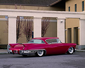 AUT 21 RK0144 01
1957 Candy Raspberry Cadillac Eldorado Kustom 3/4 Side Rear On Pavement By White Pillars And Building