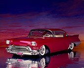 AUT 21 RK0147 03
1957 Candy Raspberry Cadillac Eldorado Kustom 3/4 Front View On Glossy Floor Sunset Background