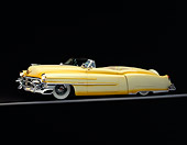 AUT 21 RK0150 09
1953 Cadillac Eldorado Convertible Yellow 3/4 Side On Gray Line Headlights On Studio Background