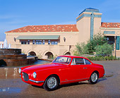 AUT 21 RK0161 08
1954 Red Fiat Vignale Coupe V8 3/4 Side View By Water Fountain And Building